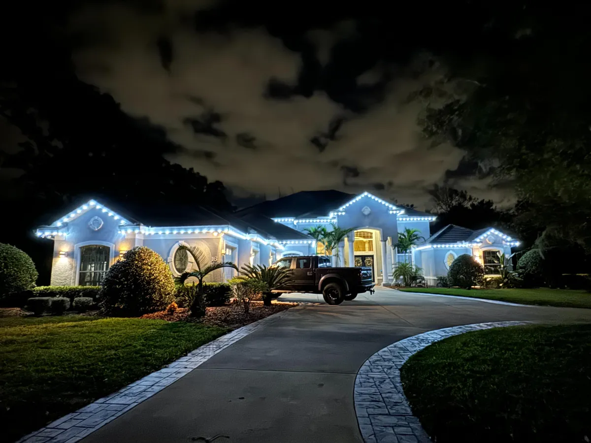 Home with bright white roofline lighting at night