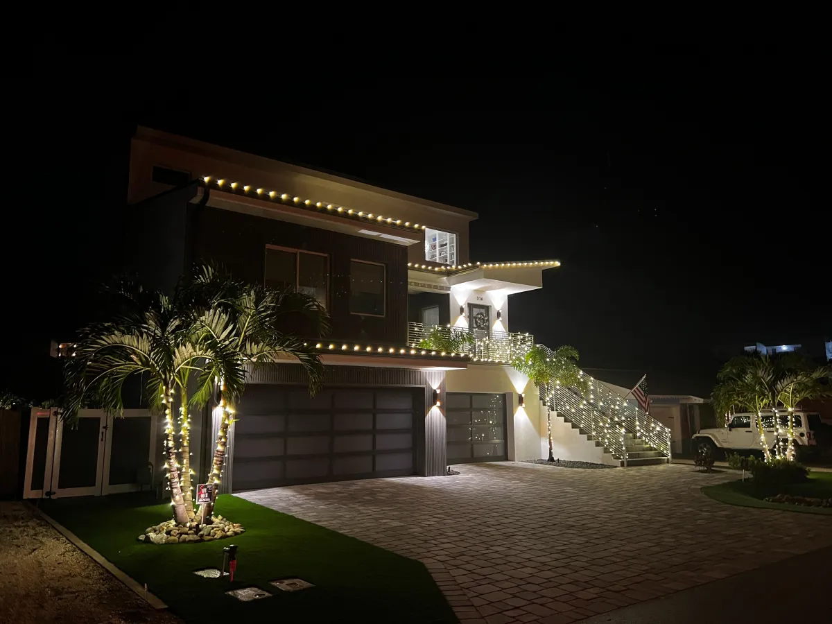 Lit walkway with staked holiday lights